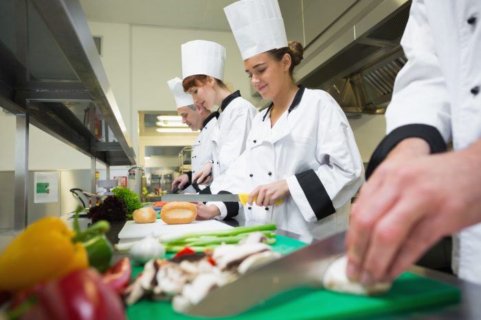 A food handler cooks ham and correctly cools